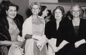 Black and white photo of four WACL members in black tie dress at the WACL ball in 1953